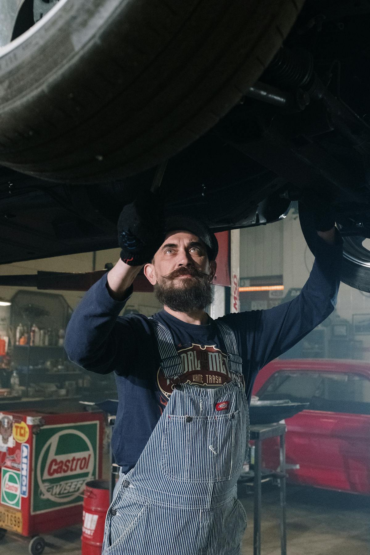 Mechanic using diagnostic tablet on car engine